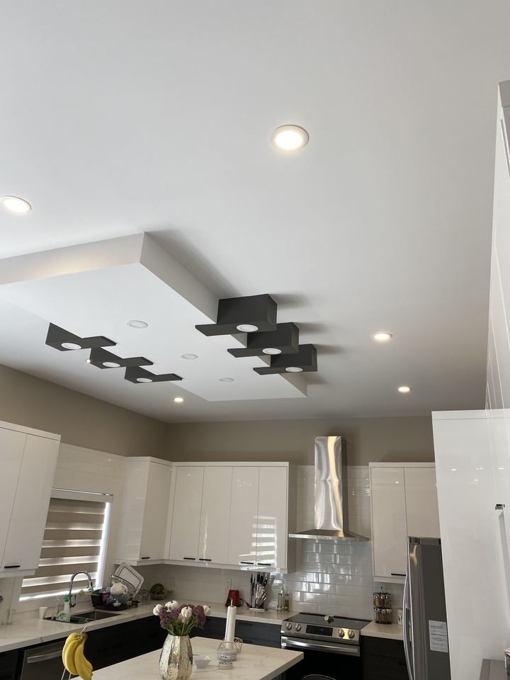 Pot lights and pendant fixtures in a kitchen ceiling