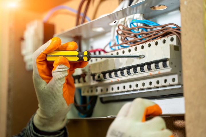 Electrician wiring a breaker panel