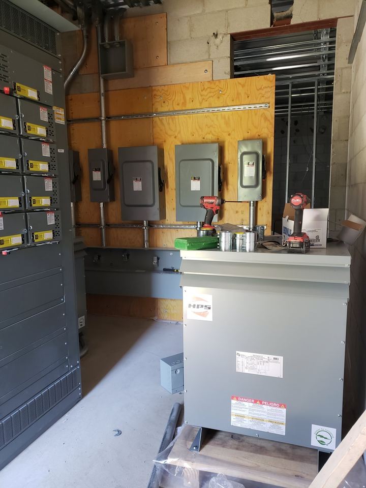Commercial electrical room with a transformer and panels