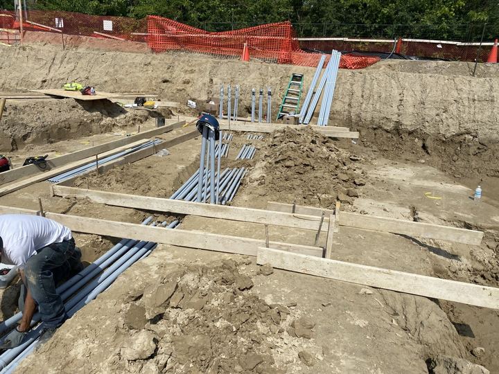 Underground conduit being installed on a construction site
