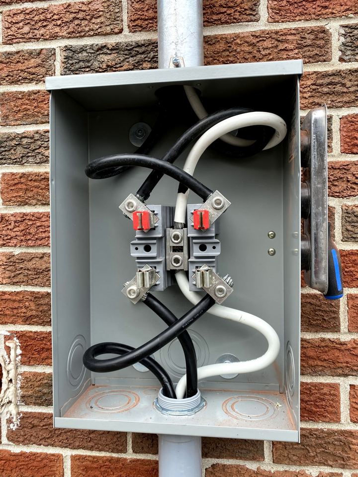 Exterior meter base on a brick wall