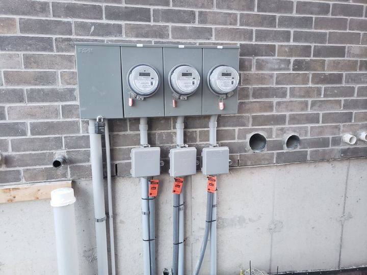 Exterior multi-meter installation on a brick wall