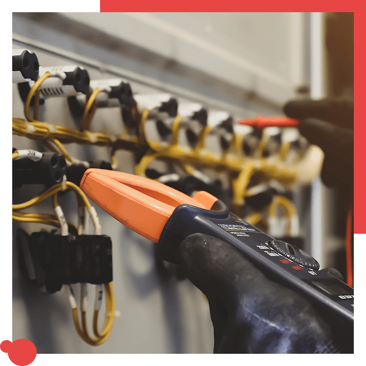 Electrician testing wiring with a clamp meter