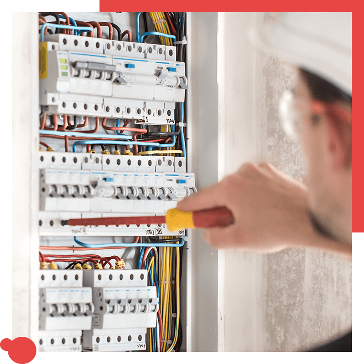 Electrician working inside a residential breaker panel